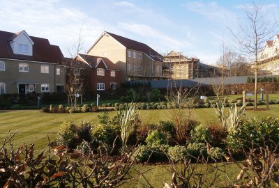 Lawn and shrub landscape outside new build homes