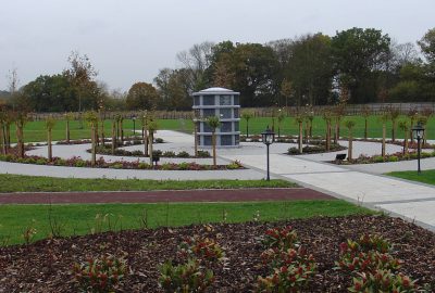 Landscaped area with paved circle path and lawn