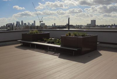 Rooftop garden with plant podiums and benches