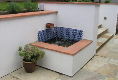 Water feature in corner of garden steps